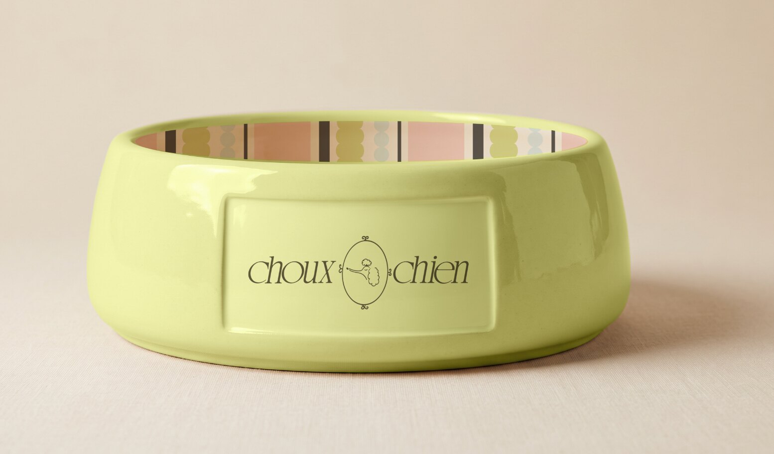 Green Choux Chien dog bowl with striped interior and poodle logo
