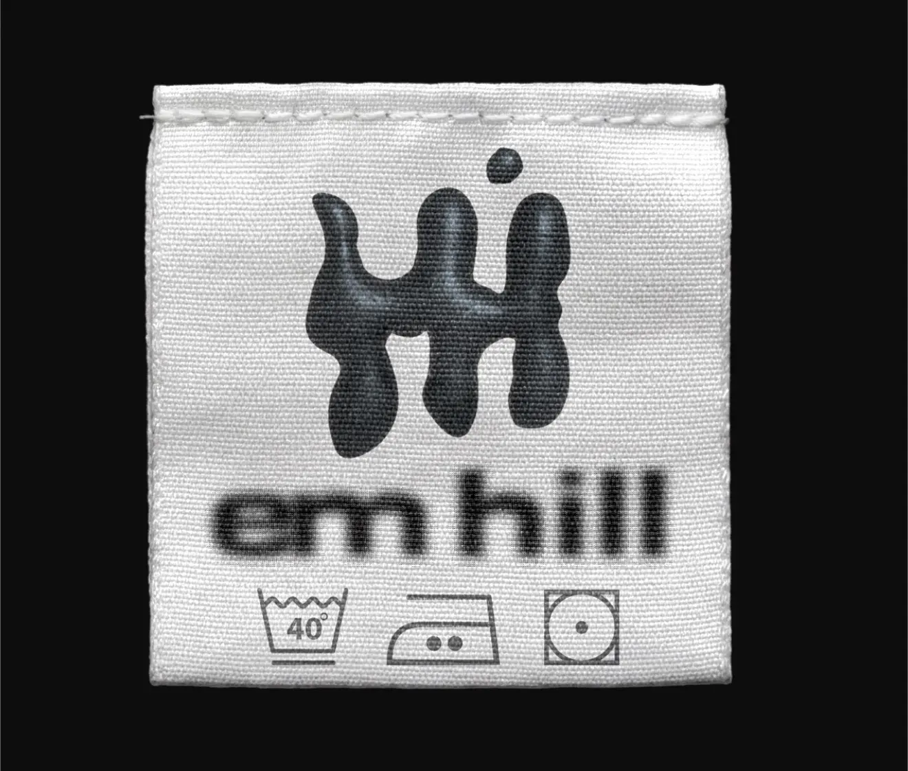 Black and white Em Hill garment care label with brand symbol
