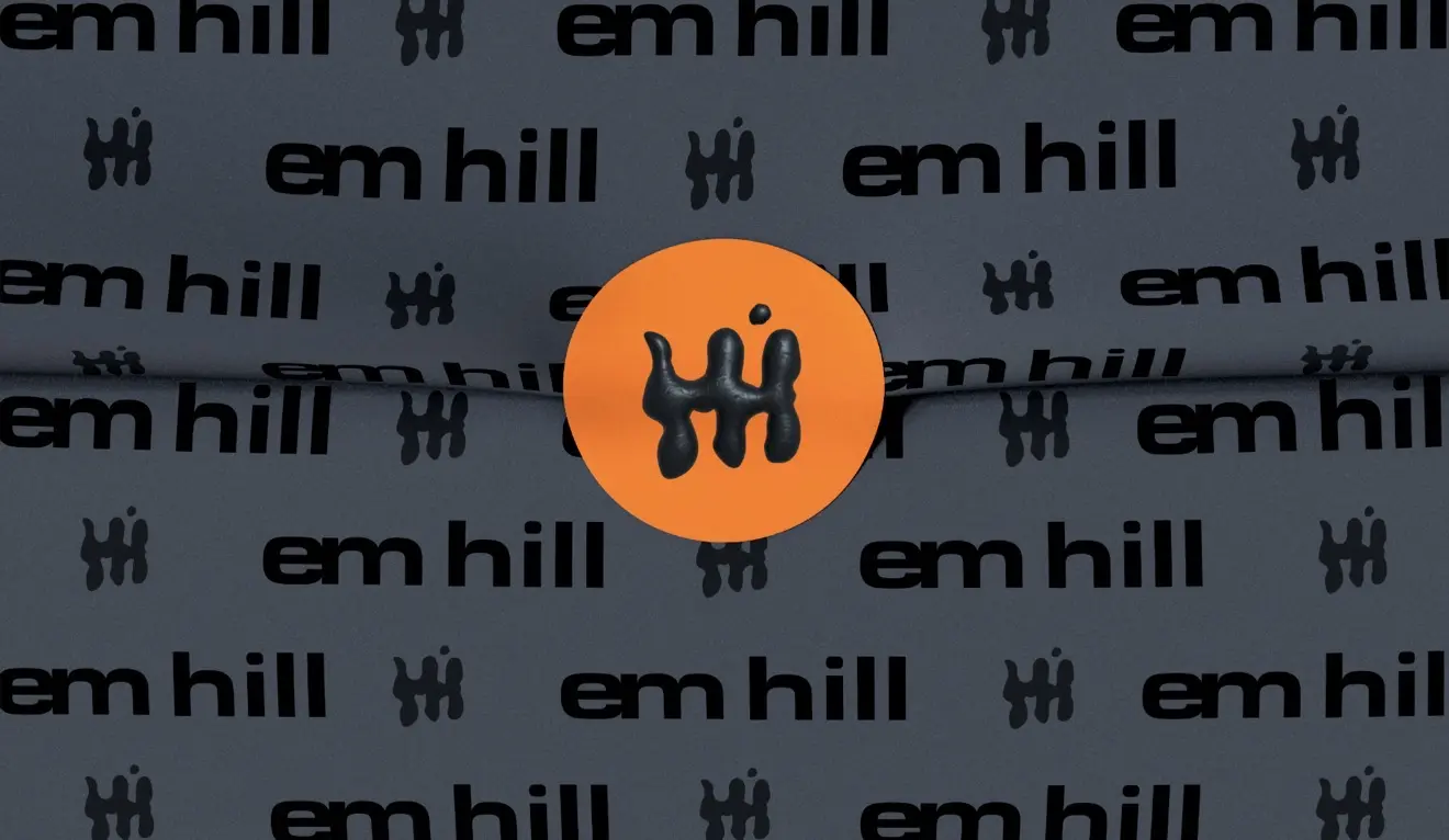Dark Em Hill patterned tissue paper sealed with an orange logo sticker