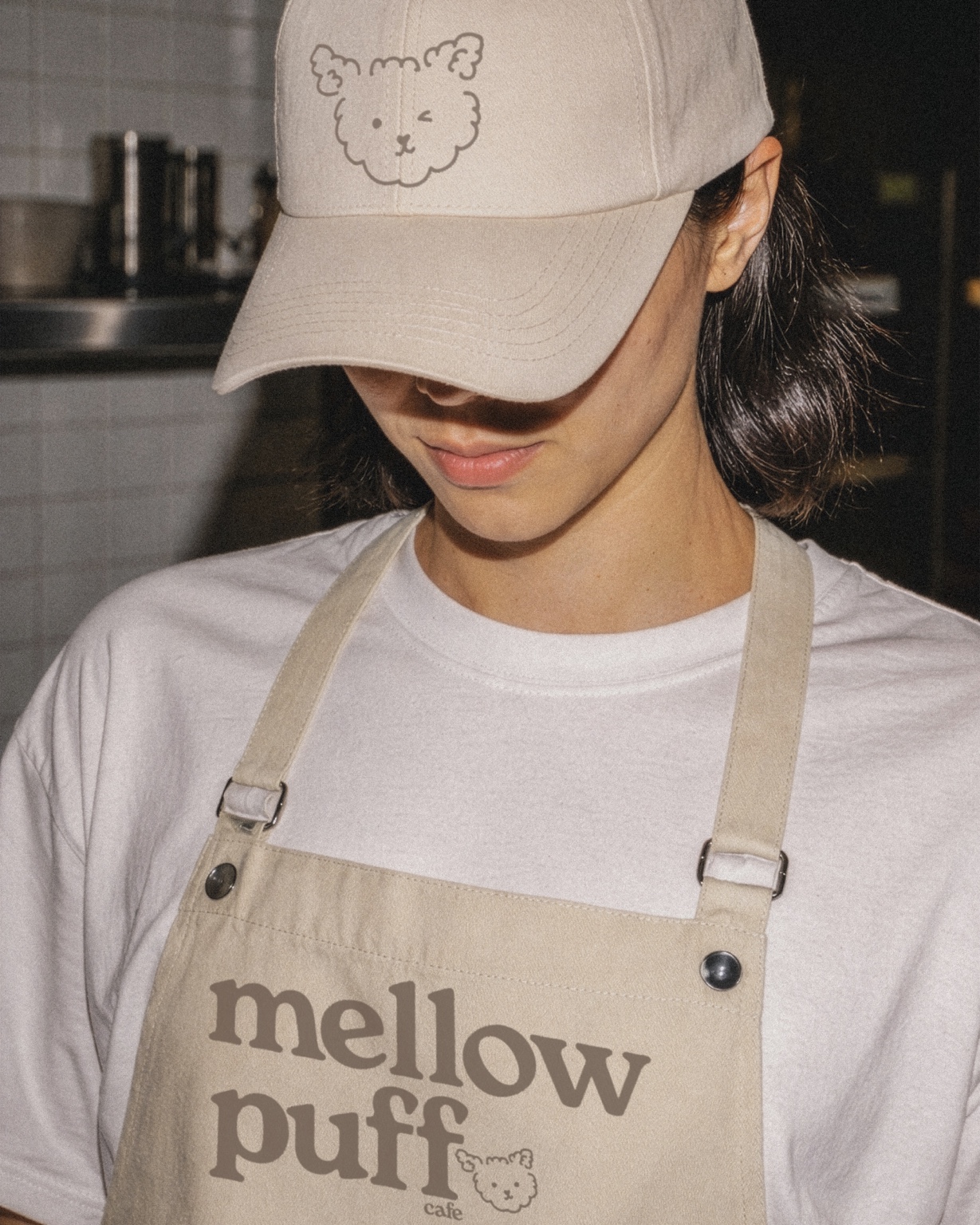 Mellow Puff Cafe employee uniform with illustrated cap and branded apron
