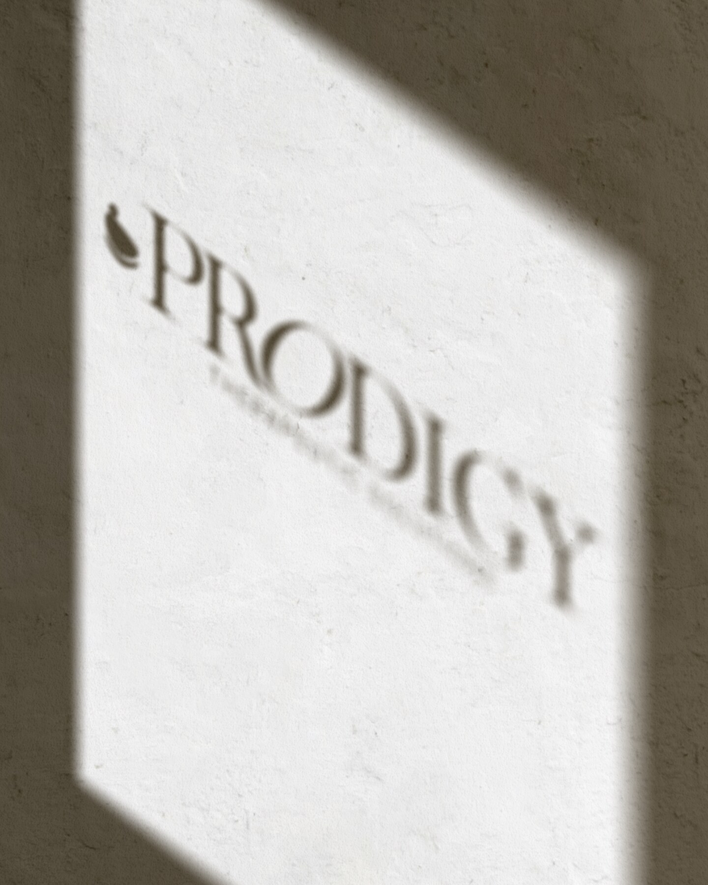 Prodigy Therapeutic Solutions logo projected softly across a wall